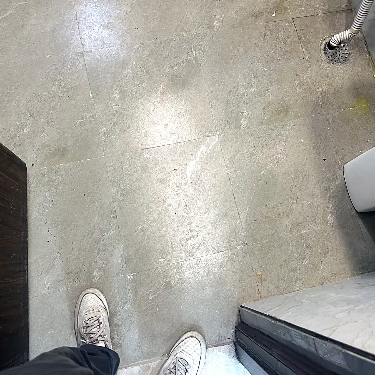 Commercial washroom floor before professional cleaning Noida