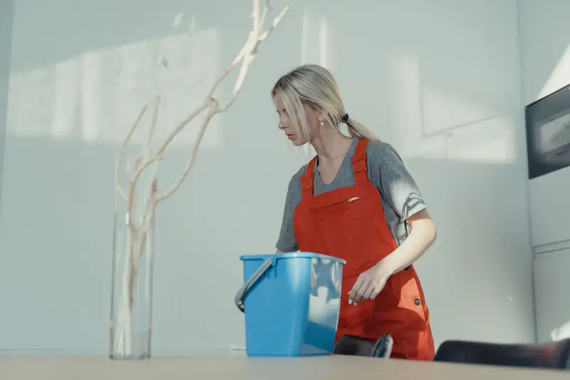 Cleaner wiping office surfaces during dust and debris removal
