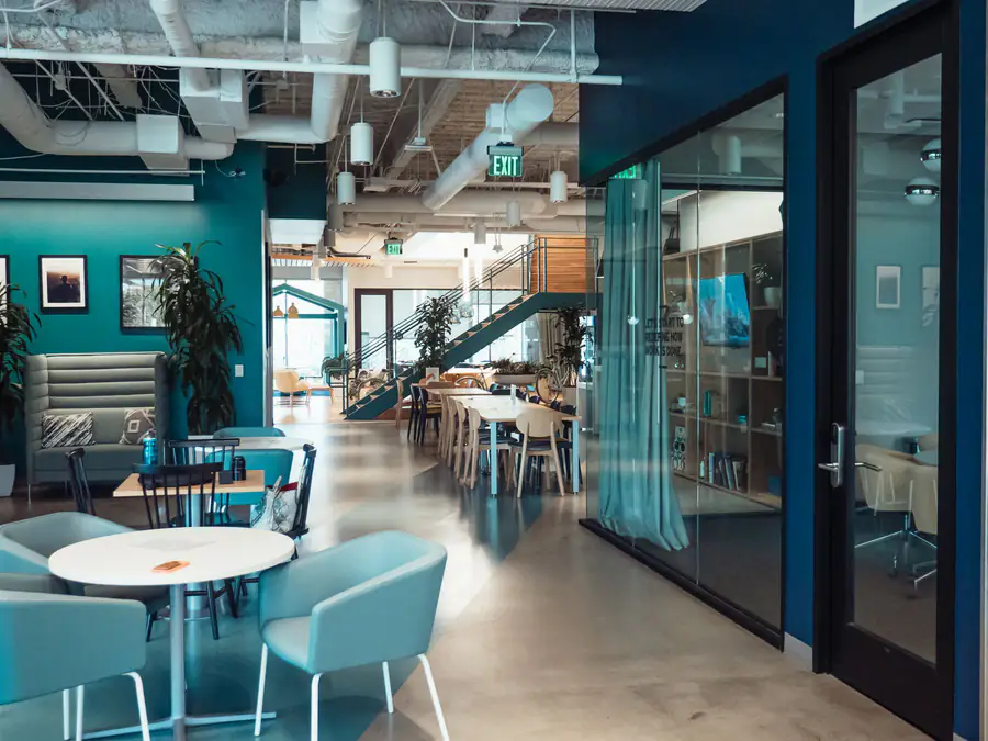 Open-plan co-working space with glass partitions and shared seating
