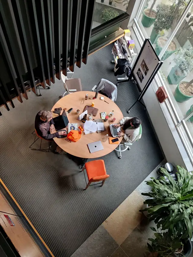 Team working around a table in a Gurugram office