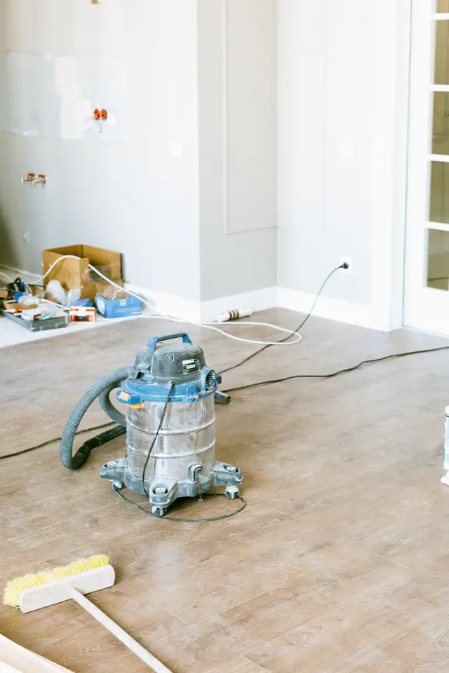 Industrial vacuum cleaner clearing construction dust after an office renovation