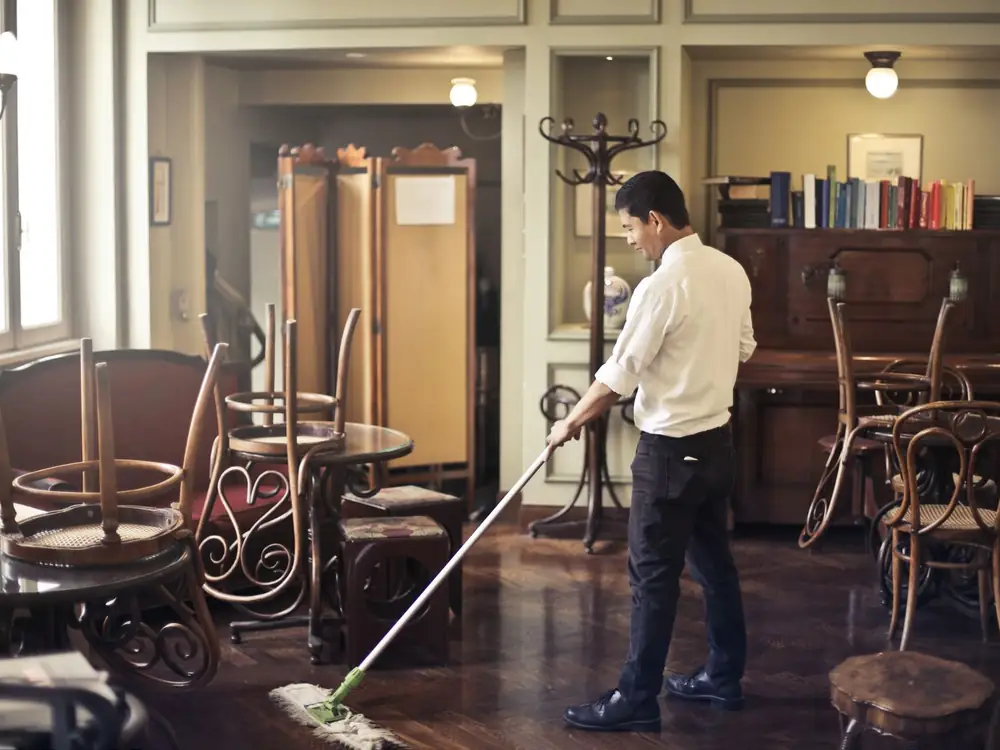 Restaurant floor being cleaned by staff