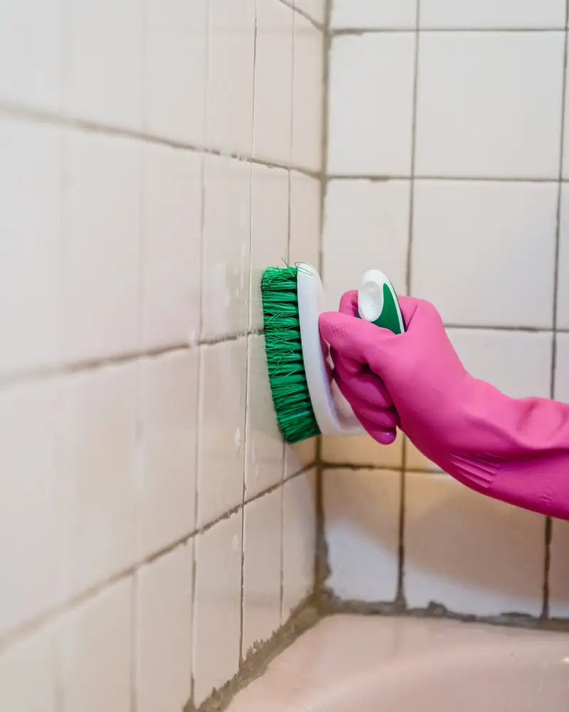 Scrubbing discoloured grout lines between tiles