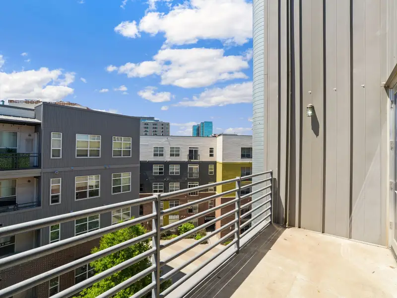Clean apartment balcony with washed floor and dust-free metal railings