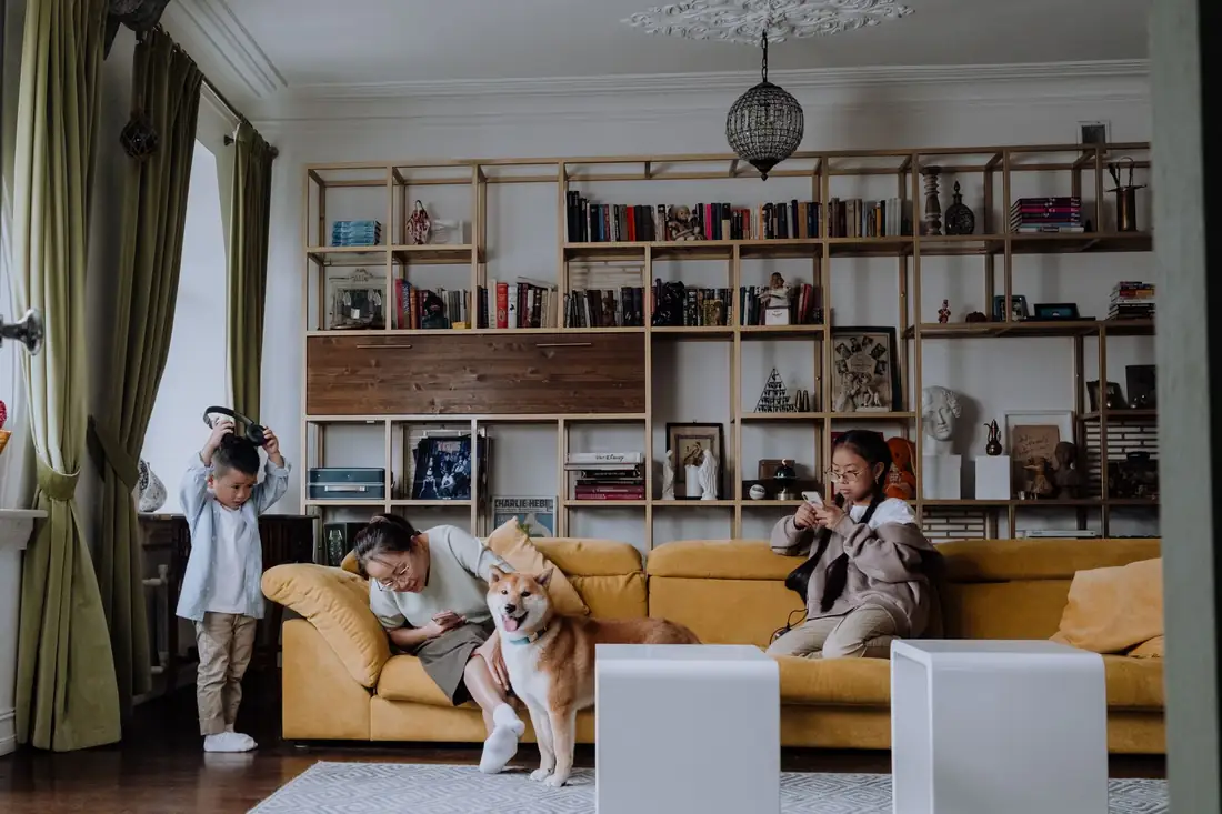 Family with children and a pet dog relaxing in a clean, freshly deep-cleaned living room