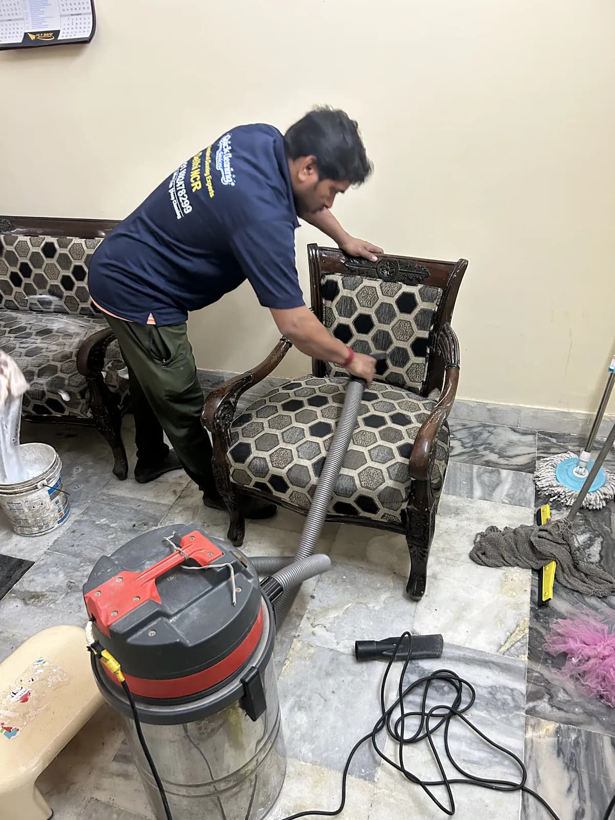 Industrial upholstery steam cleaning machine in use on sofa in Delhi home