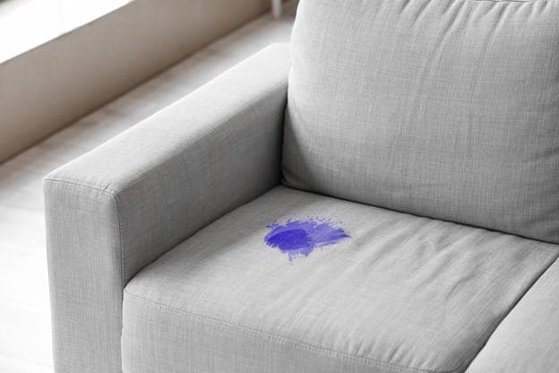 Ink and marker stain on sofa upholstery in Delhi home