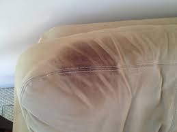 Sweat and body oil stain on sofa causing discolouration — deep cleaned in Delhi
