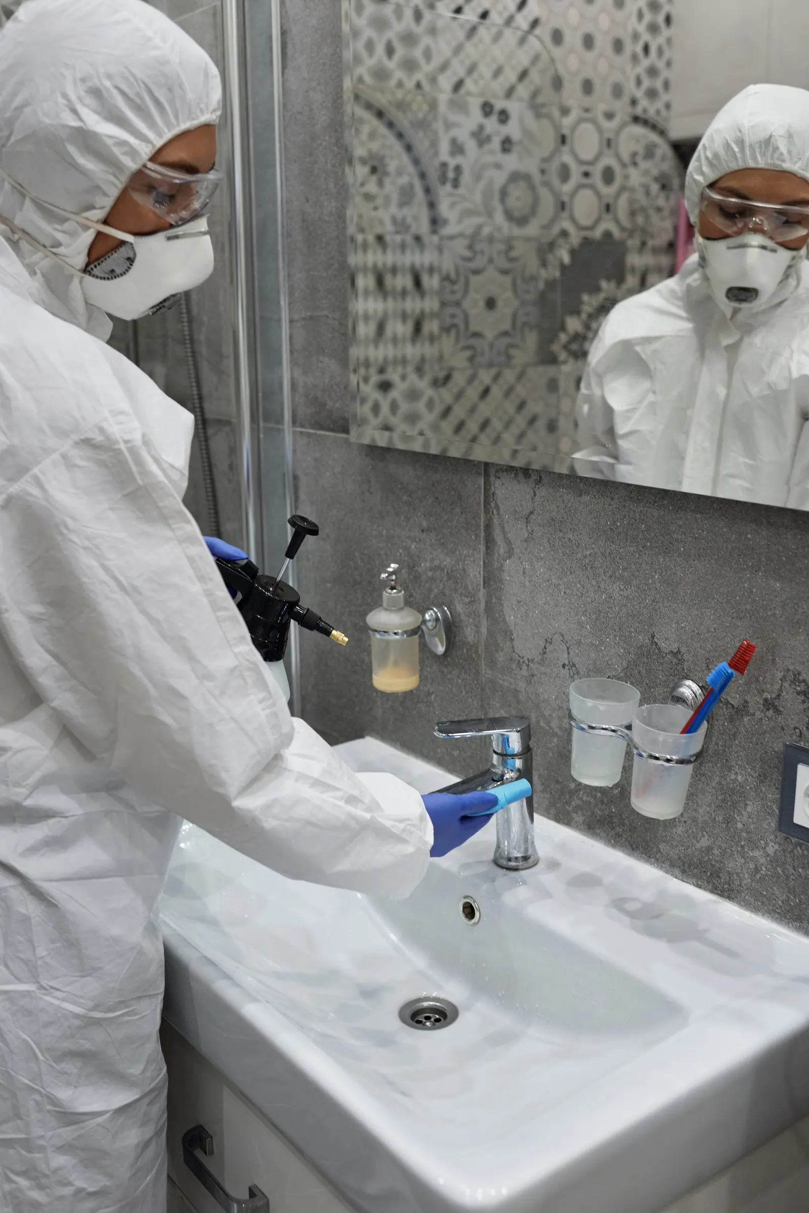Washroom fixtures being disinfected during a home sanitization service in Delhi NCR